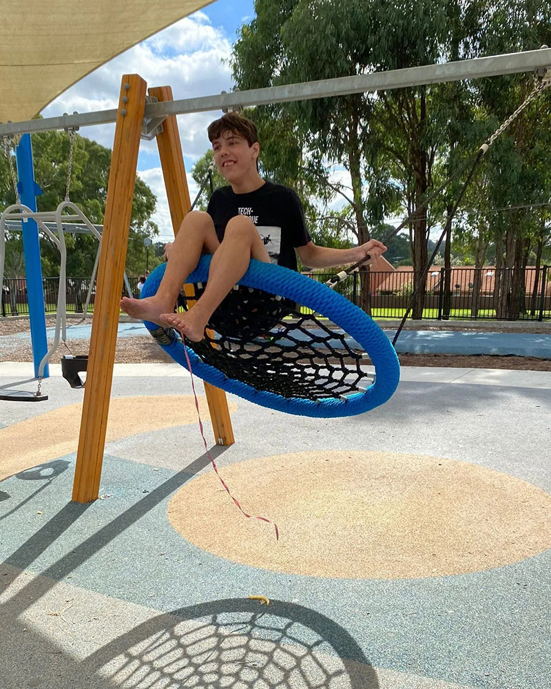 Boy is playing with the swing in a happy moment