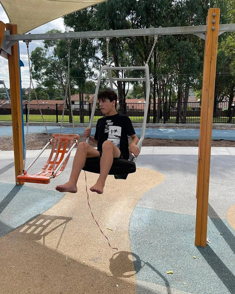 Boy is playing with the swing