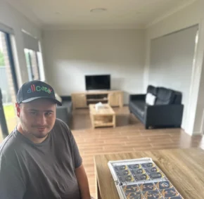 man is taking a picture while sitting behind big table