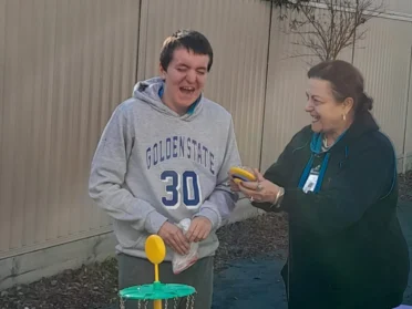 Teacher is playing with a young man called bailey game